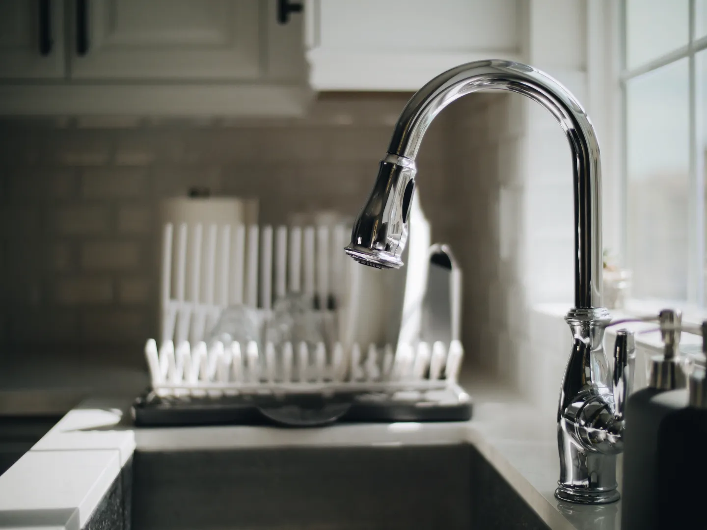 Faucet & Fixture Repair — Kitchen Chrome Faucet Service Toronto GTA Grey kitchen sink with shiny chrome faucet repaired by licensed plumber in Toronto GTA