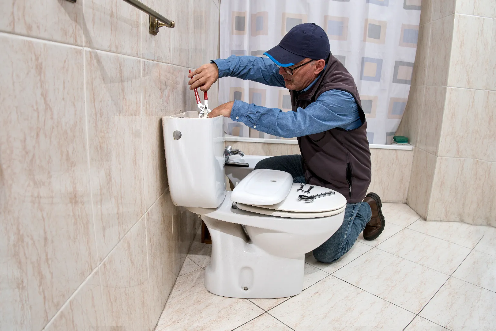 Toilet Repair and Replacement: Cistern Repair Service Toronto GTA Licensed plumber repairing toilet cistern, professional toilet repair and replacement service in Toronto GTA