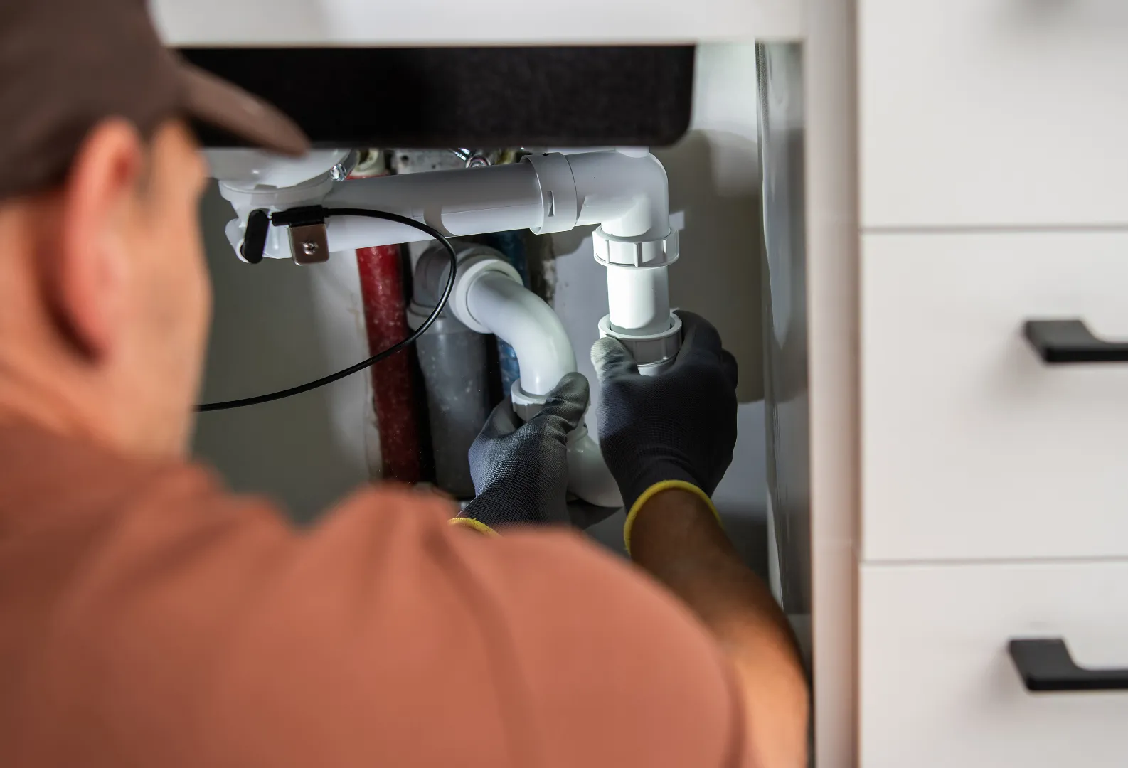 Water Line Repair: Sink Drainage Installation Service Toronto GTA Professional plumber installing new sink drainage system during water line repair in Toronto GTA